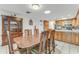 Dining room adjacent to the kitchen with wood table, chairs, and built-in china cabinet at 1730 Birmingham Ave, Daytona Beach, FL 32117
