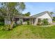 Single-story home featuring a well-maintained lawn and red shutters at 1730 Birmingham Ave, Daytona Beach, FL 32117