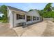 View of side exterior featuring red shutters and a concrete patio at 1730 Birmingham Ave, Daytona Beach, FL 32117
