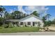 Charming single-story home with white brick facade, landscaped front yard, and lush greenery at 1730 Birmingham Ave, Daytona Beach, FL 32117
