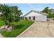 Single story home with a concrete driveway and front lawn with landscaping at 1730 Birmingham Ave, Daytona Beach, FL 32117