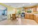 Bright kitchen with wooden cabinets, stainless steel appliances, and adjacent breakfast nook area at 1730 Birmingham Ave, Daytona Beach, FL 32117