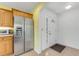 Kitchen featuring stainless steel refrigerator next to front entrance and tiled floors at 1730 Birmingham Ave, Daytona Beach, FL 32117