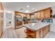 Spacious kitchen with stainless steel appliances, wood cabinets, and tile floors at 1730 Birmingham Ave, Daytona Beach, FL 32117