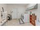 Well-lit laundry room featuring a modern washer and dryer set and tile floors at 1730 Birmingham Ave, Daytona Beach, FL 32117
