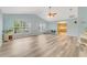 Spacious living room with vaulted ceilings, lots of natural light, and wood-look flooring at 1730 Birmingham Ave, Daytona Beach, FL 32117