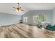 Open floor plan living room featuring wood-look floors and natural light at 1730 Birmingham Ave, Daytona Beach, FL 32117