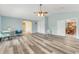 Large living room featuring high ceilings, and wood-look floors that flow throughout the home at 1730 Birmingham Ave, Daytona Beach, FL 32117