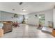 Open living room featuring neutral paint, tiled floors, and large windows at 1730 Birmingham Ave, Daytona Beach, FL 32117