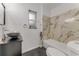 Modern bathroom boasting marble tile wall, sleek vanity, and vessel sink, providing a stylish and functional space at 182 Grove St, Ormond Beach, FL 32174