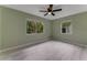 Bedroom featuring wood-look flooring and views to the greenery outside, bathed in natural light at 182 Grove St, Ormond Beach, FL 32174