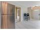 Kitchen featuring stainless steel refrigerator, eat-in area with seating, and clear view to the main living area at 182 Grove St, Ormond Beach, FL 32174