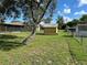 Fenced backyard with a small storage shed and mature trees at 1887 Viking Ave, Deltona, FL 32725