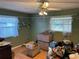 Cozy bedroom with hardwood floors, a ceiling fan, and two windows at 1887 Viking Ave, Deltona, FL 32725