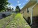 View of the side of the home with a fenced yard and various utilities at 1887 Viking Ave, Deltona, FL 32725