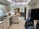 Traditional-style kitchen with neutral countertops and stainless-steel dishwasher at 1887 Viking Ave, Deltona, FL 32725