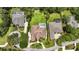 Aerial view of a home with a brown roof and screened pool situated between similar residential properties at 19 Tomoka Cove Way, Ormond Beach, FL 32174