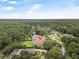 Aerial view showing the verdant surrounding trees, a place of peace and quiet at 19 Tomoka Cove Way, Ormond Beach, FL 32174