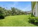 A generous backyard is framed by mature trees, offering a serene outdoor space at 19 Tomoka Cove Way, Ormond Beach, FL 32174