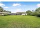 A beautifully landscaped backyard with a screened lanai offers a serene outdoor space at 19 Tomoka Cove Way, Ormond Beach, FL 32174