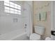 White bathroom with bathtub and shower, towel rack, and commode at 19 Tomoka Cove Way, Ormond Beach, FL 32174