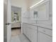Bathroom featuring stylish white cabinetry and granite countertop offers storage and functionality with easy access to the bedroom at 19 Tomoka Cove Way, Ormond Beach, FL 32174
