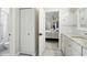 Bright bathroom leading into bedroom featuring granite counters and hardwood floors at 19 Tomoka Cove Way, Ormond Beach, FL 32174