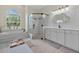 Stylish bathroom featuring a tub, walk-in shower, and dual vanities at 19 Tomoka Cove Way, Ormond Beach, FL 32174