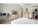 Bedroom with a mounted television over the wooden dresser, and closet with surfboards inside at 19 Tomoka Cove Way, Ormond Beach, FL 32174