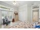 Bright bedroom with ceiling fan, closet, and french doors to screened porch at 19 Tomoka Cove Way, Ormond Beach, FL 32174