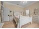 Bedroom featuring white furnishings, hardwood floors, and a bright and airy ambiance creates a peaceful and inviting retreat at 19 Tomoka Cove Way, Ormond Beach, FL 32174