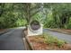 A picturesque entrance to The Preserve community, surrounded by lush trees and landscaping at 19 Tomoka Cove Way, Ormond Beach, FL 32174