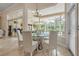 Bright dining area featuring a round glass table with seating for six and views of the pool at 19 Tomoka Cove Way, Ormond Beach, FL 32174