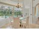 Cozy dining area with neutral tones and views of the screened pool at 19 Tomoka Cove Way, Ormond Beach, FL 32174