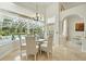 Eat-in kitchen dining area with view of screened-in pool and backyard at 19 Tomoka Cove Way, Ormond Beach, FL 32174