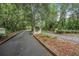 Entrance to The Preserve featuring a curved sign, mature trees, and a tranquil, wooded atmosphere at 19 Tomoka Cove Way, Ormond Beach, FL 32174