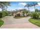 Stately home with three-car garage, beautiful landscaping, and a circular driveway at 19 Tomoka Cove Way, Ormond Beach, FL 32174