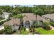 Beautiful home featuring tile roof, well maintained landscaping, and a stately entrance with decorative glass doors at 19 Tomoka Cove Way, Ormond Beach, FL 32174
