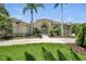 Exterior view of a light yellow stucco home with beautiful landscaping, and a brick walkway at 19 Tomoka Cove Way, Ormond Beach, FL 32174