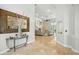 Inviting foyer with travertine floors flows into a spacious living area, bathed in natural light with modern decor at 19 Tomoka Cove Way, Ormond Beach, FL 32174
