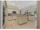 Bright kitchen with neutral tones, a large island, granite countertops, and ample cabinet space at 19 Tomoka Cove Way, Ormond Beach, FL 32174