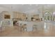 Open-concept kitchen featuring bar stool seating and views to the entryway and front door at 19 Tomoka Cove Way, Ormond Beach, FL 32174