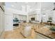 Open kitchen with granite countertops, modern appliances, and a central island for entertaining and cooking at 19 Tomoka Cove Way, Ormond Beach, FL 32174