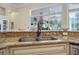 Elegant kitchen sink with granite countertops, a neutral backsplash, and views of the pool area at 19 Tomoka Cove Way, Ormond Beach, FL 32174