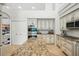 Gourmet kitchen featuring a large center island, stainless steel appliances, and ample counter space at 19 Tomoka Cove Way, Ormond Beach, FL 32174