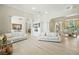 Open-concept living room with hardwood floors, neutral decor, and seamless flow to dining area at 19 Tomoka Cove Way, Ormond Beach, FL 32174