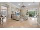 Spacious living room with high ceilings, fireplace, and sliding glass doors to the outdoor patio at 19 Tomoka Cove Way, Ormond Beach, FL 32174