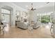 Open-concept living room with fireplace and view of screened-in outdoor patio at 19 Tomoka Cove Way, Ormond Beach, FL 32174