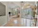 Open living room with grand entryway, tile floors, and ample natural light at 19 Tomoka Cove Way, Ormond Beach, FL 32174