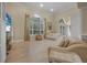 Bright living room featuring hardwood floors, large windows, and comfortable seating at 19 Tomoka Cove Way, Ormond Beach, FL 32174